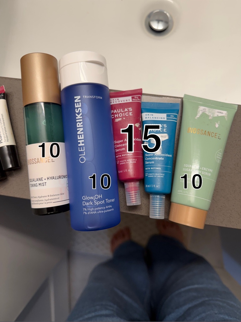 Ole Henriksen blue toner with green and gold-accented skincare